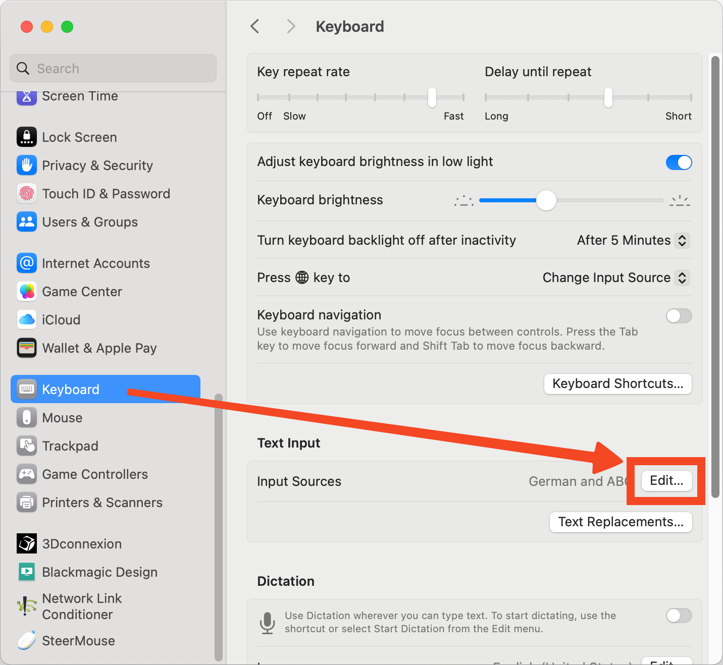 macOS System Settings window open to the Keyboard section with the Text Input area visible. The Edit button next to Input Sources is highlighted in blue. The sidebar on the left lists other settings categories such as Appearance, Control Center, and Siri and Spotlight. The overall tone is neutral and instructional. Visible text includes System Settings, Keyboard, Text Input, and Edit.